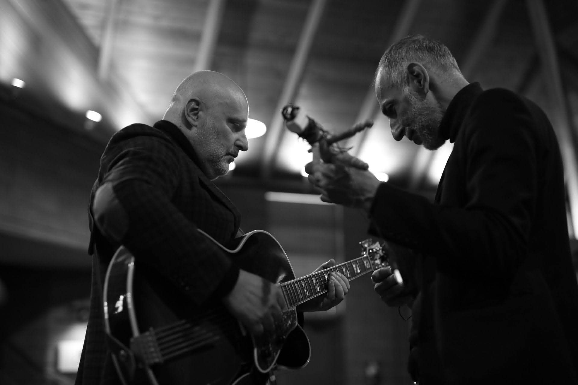 Musicians playing guitar and percussion