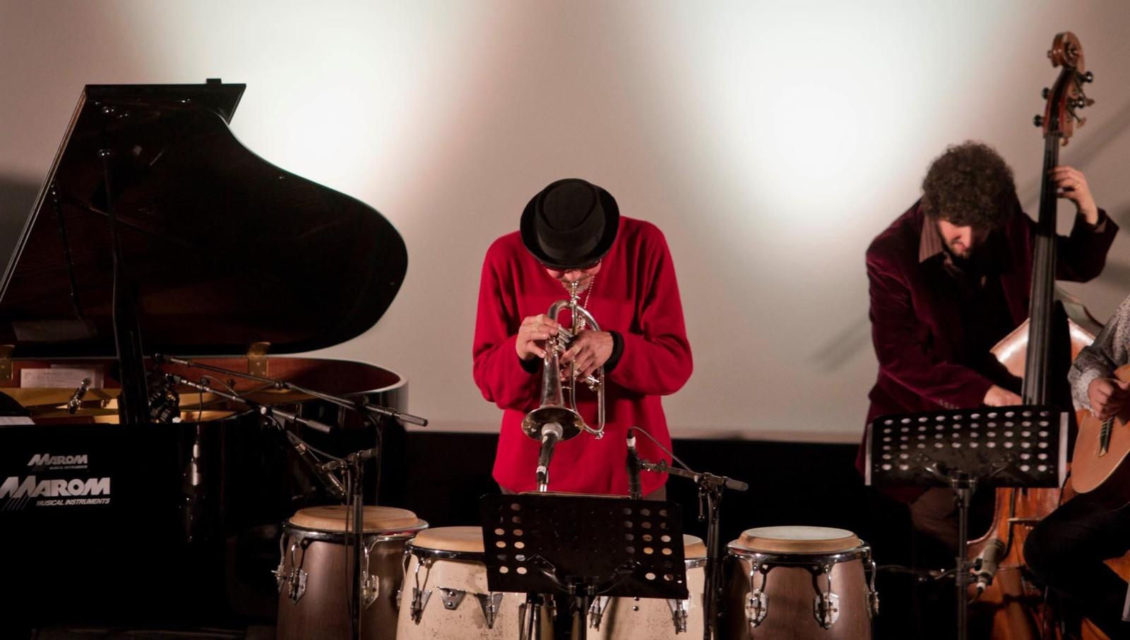 Jerry González performing in a red shirt with Sound of the Ground
